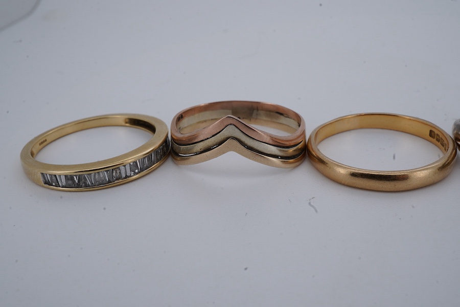 Six rings, comprising: a half eternity ring channel-set with tapered baguette diamonds, mounted in 18ct gold, size P1/2, British hallmarks, gross weight approximately 3 grams; one of half-hoop design, set with brilliant-